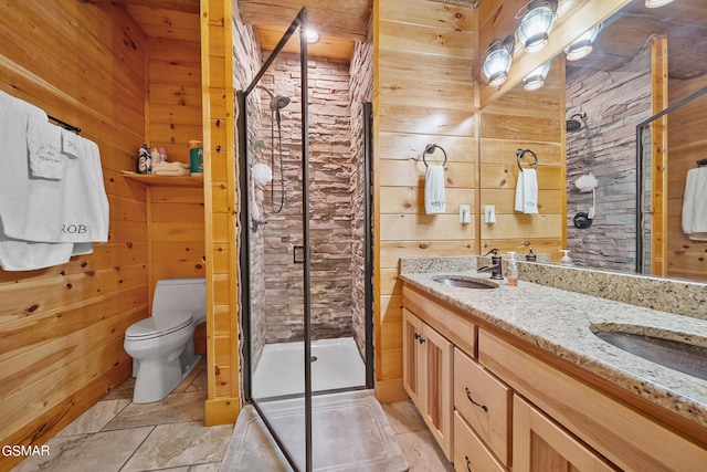 bathroom with vanity, toilet, an enclosed shower, and wooden walls