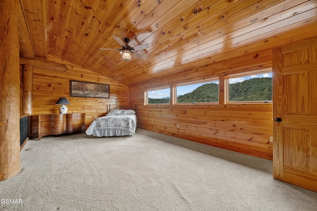 unfurnished bedroom featuring carpet, wooden ceiling, wooden walls, and vaulted ceiling