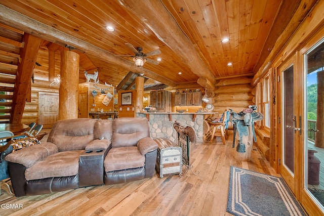 living room featuring beamed ceiling, wooden ceiling, log walls, and light hardwood / wood-style flooring