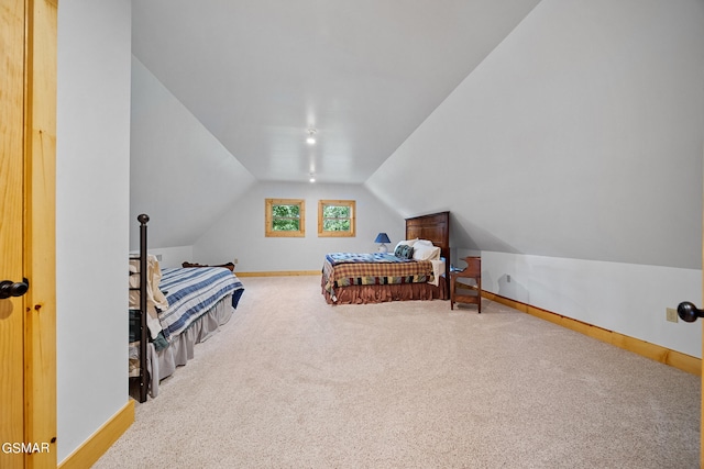 carpeted bedroom with vaulted ceiling