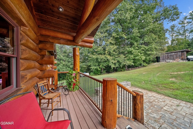 wooden terrace featuring a lawn