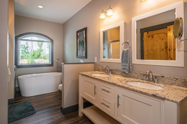 907 Village Loop Rd, Gatlinburg, TN 37738 - bathroom with vanity, toilet, wood-type flooring, and a tub