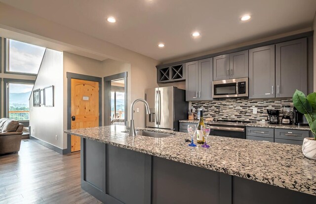 907 Village Loop Rd, Gatlinburg, TN 37738 - kitchen with backsplash, light stone counters, gray cabinetry, stainless steel appliances, and sink