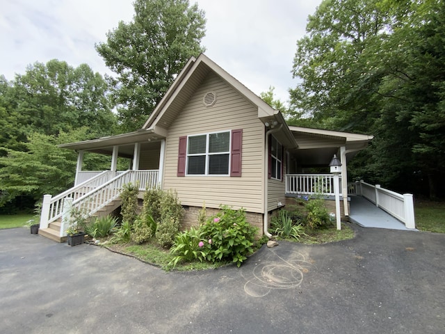 view of front of house featuring a porch and a carport