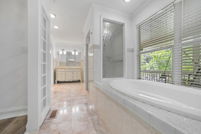 bathroom with vanity, crown molding, and independent shower and bath