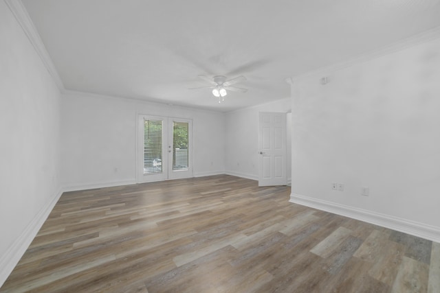 empty room featuring french doors, light hardwood / wood-style floors, ceiling fan, and ornamental molding