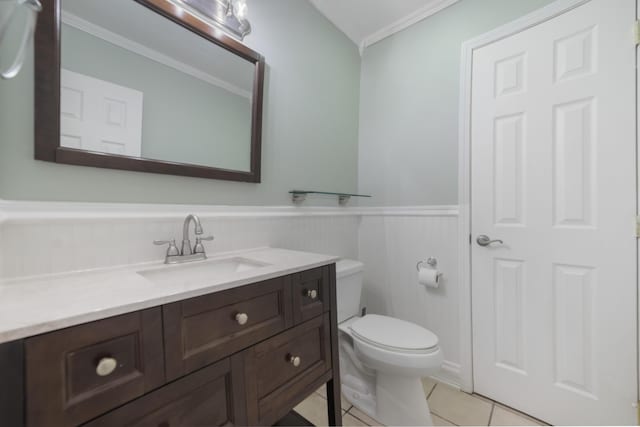 bathroom with tile patterned floors, crown molding, vanity, and toilet