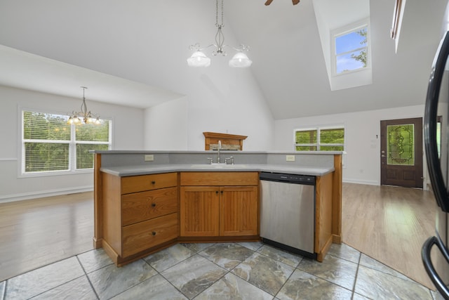 kitchen featuring pendant lighting, dishwasher, ceiling fan with notable chandelier, refrigerator, and sink