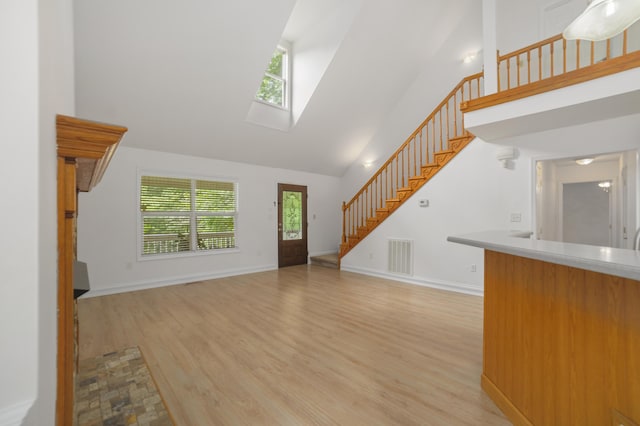 living room featuring a high ceiling and light wood-type flooring