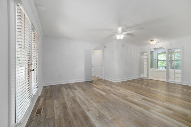 unfurnished living room with light wood-type flooring, ceiling fan, and crown molding