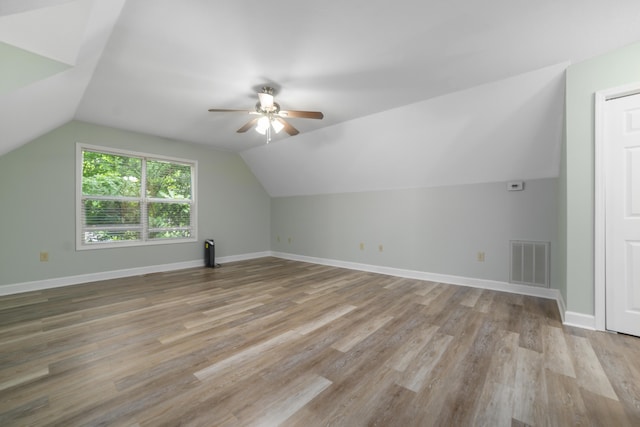 bonus room with light hardwood / wood-style flooring, vaulted ceiling, and ceiling fan