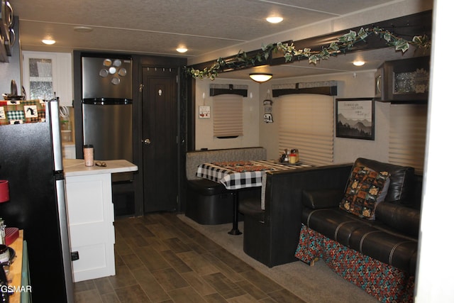 kitchen featuring light countertops, wood tiled floor, and freestanding refrigerator