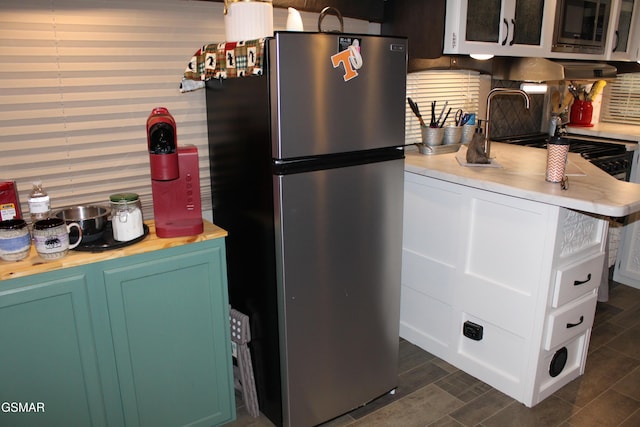 kitchen featuring decorative backsplash, appliances with stainless steel finishes, and wood tiled floor