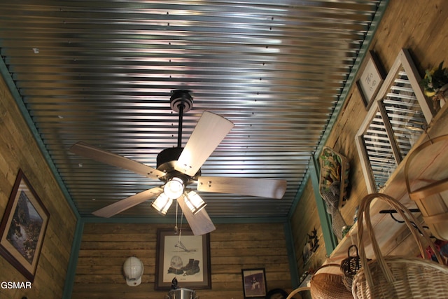 details featuring ceiling fan and wood walls