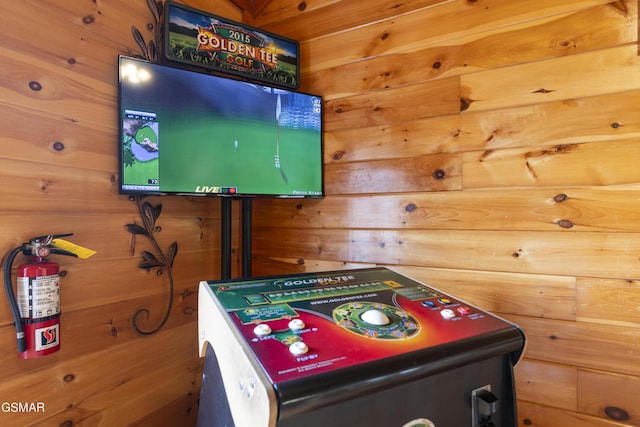 game room with wood walls