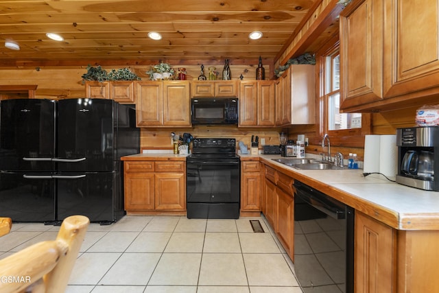 kitchen with wood walls, black appliances, sink, light tile patterned floors, and wood ceiling