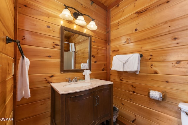 bathroom featuring vanity and wooden walls