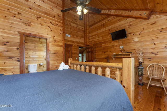 unfurnished bedroom featuring hardwood / wood-style floors, vaulted ceiling with beams, ceiling fan, and wooden ceiling