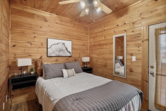 bedroom featuring hardwood / wood-style floors, ceiling fan, and wood ceiling