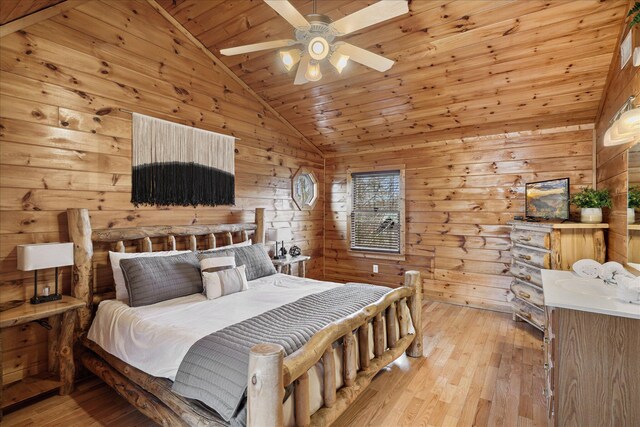 bedroom with ceiling fan, wooden ceiling, light hardwood / wood-style flooring, vaulted ceiling, and wooden walls