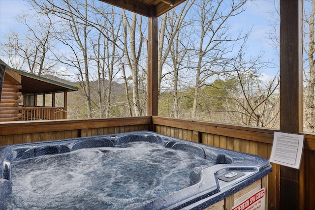 wooden terrace featuring a hot tub