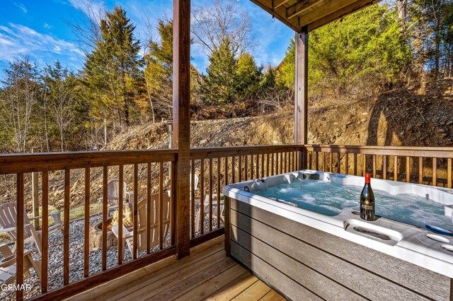 wooden terrace with a hot tub