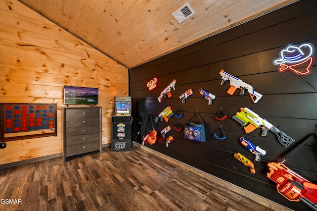 playroom featuring lofted ceiling, dark wood-style flooring, wood walls, wood ceiling, and visible vents