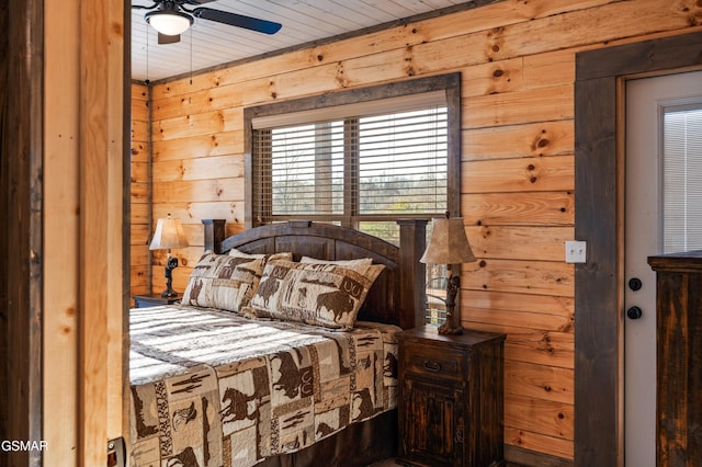 bedroom featuring wooden walls