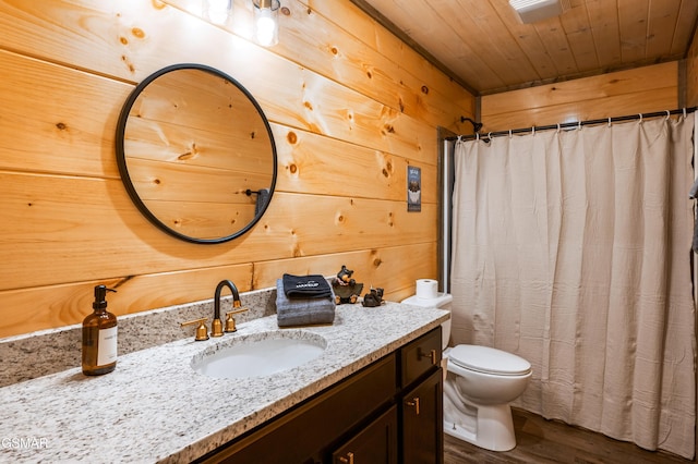 bathroom with toilet, wood ceiling, wooden walls, vanity, and wood finished floors