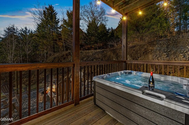 deck featuring an outdoor hot tub