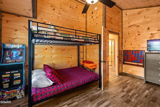 bedroom with wood walls, wood finished floors, and wood ceiling