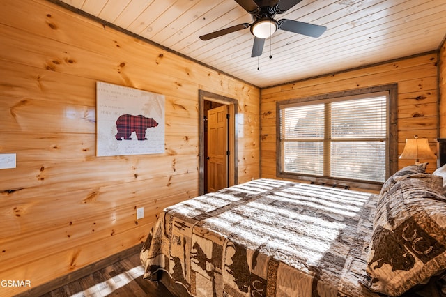 bedroom with wood walls, wooden ceiling, and wood finished floors