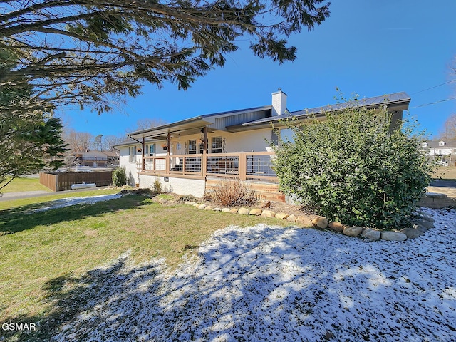 exterior space featuring a lawn, a chimney, and fence