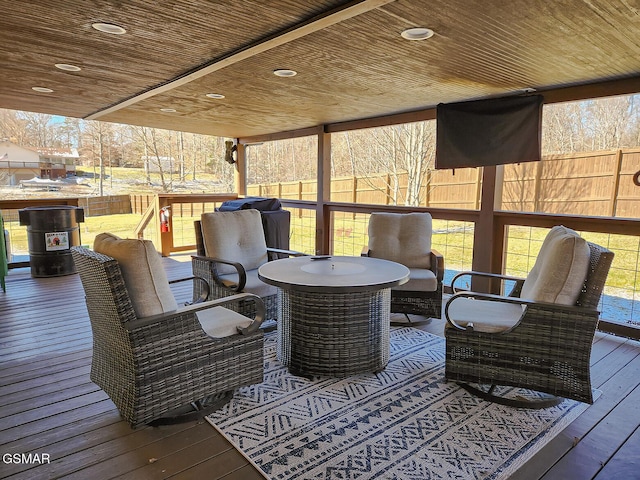 wooden terrace featuring outdoor lounge area and fence