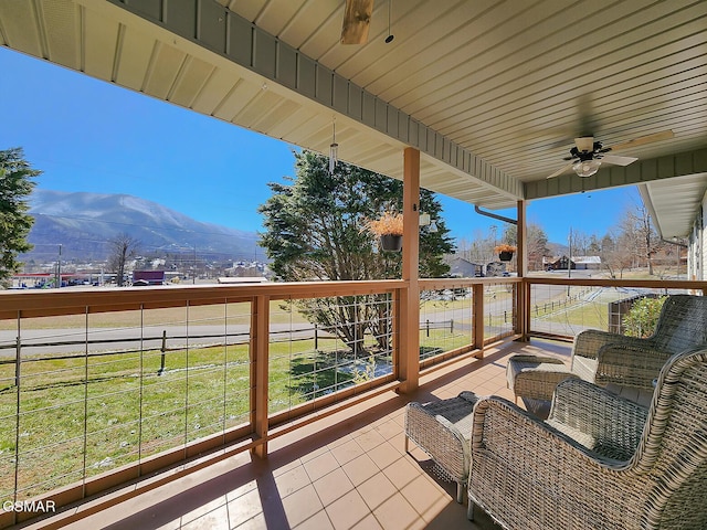 exterior space with a mountain view and ceiling fan