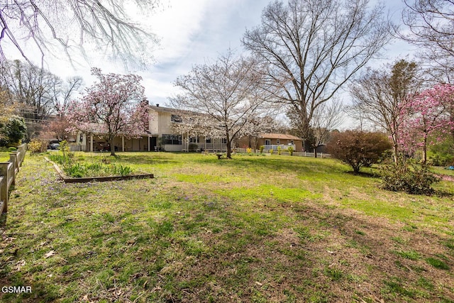 view of yard featuring a vegetable garden and fence