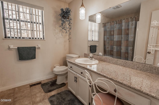 bathroom with visible vents, toilet, vanity, and baseboards