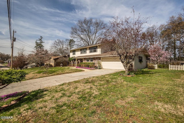 traditional-style house with stucco siding, fence, concrete driveway, an attached garage, and a front yard