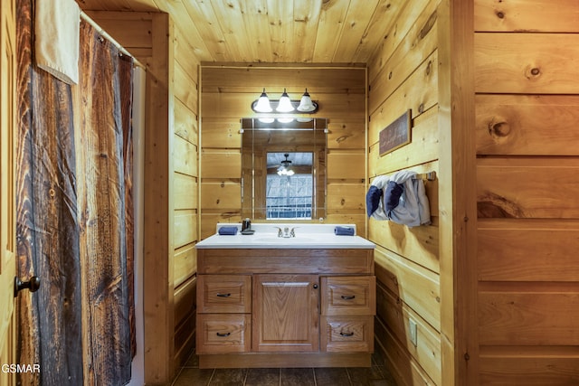 bathroom featuring a shower with curtain, wood ceiling, wooden walls, and vanity