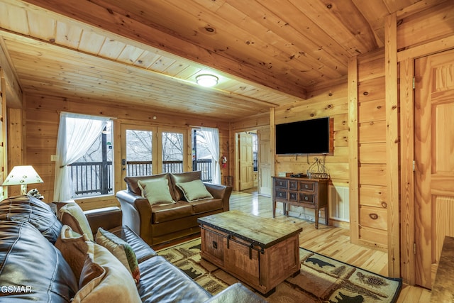 living room featuring wooden ceiling, wood walls, light wood-style flooring, and beam ceiling