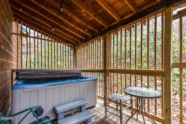 sunroom / solarium featuring wood ceiling, rail lighting, a jacuzzi, and vaulted ceiling with beams