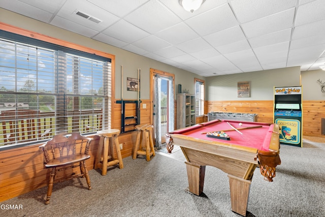 recreation room with a paneled ceiling, wood walls, carpet, and pool table