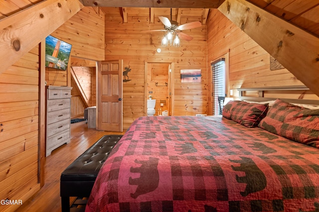 bedroom with wood ceiling, lofted ceiling, light wood-type flooring, and wooden walls