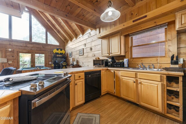 1251 Bear Cub Way, Gatlinburg, TN 37738 - kitchen featuring stainless steel appliances, light wood-style flooring, a sink, wood walls, and tile counters