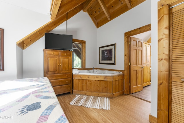 1251 Bear Cub Way, Gatlinburg, TN 37738 - bedroom with lofted ceiling with beams, wooden ceiling, and light wood-style floors