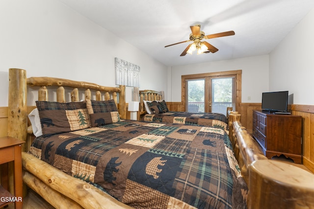 1251 Bear Cub Way, Gatlinburg, TN 37738 - bedroom featuring wooden walls, ceiling fan, access to outside, and wainscoting