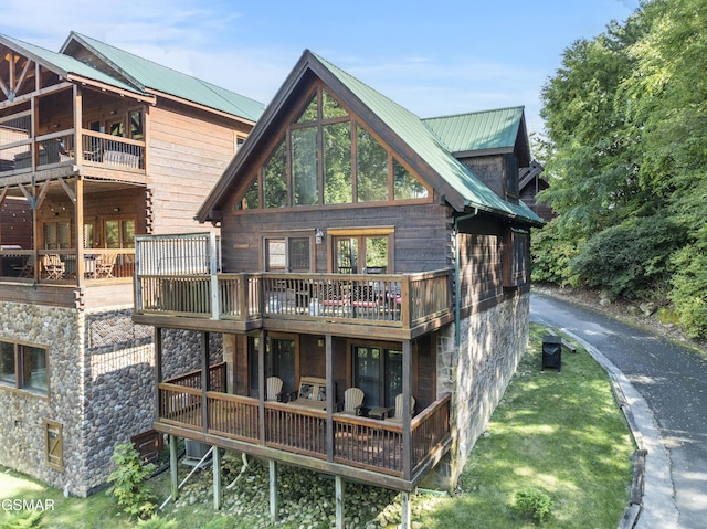 1251 Bear Cub Way, Gatlinburg, TN 37738 - rear view of house with a yard, a balcony, stone siding, and metal roof