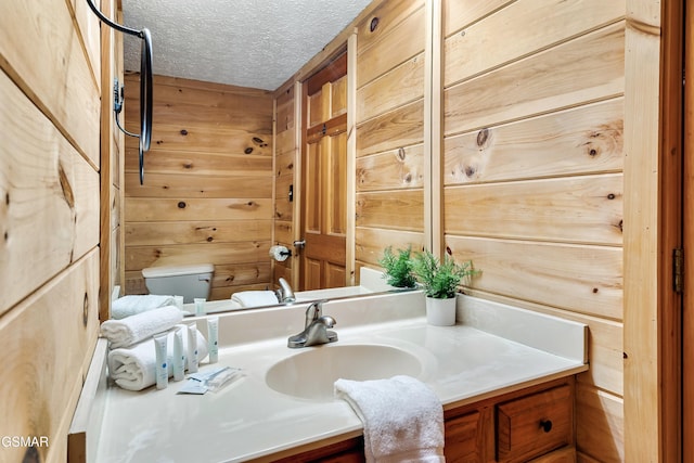 2904 Peregrine Way, Pigeon Forge, TN 37863 - half bath featuring vanity, wooden walls, and a textured ceiling