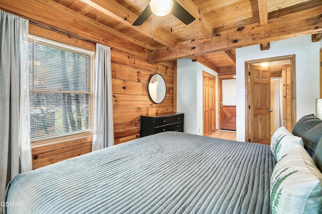 2904 Peregrine Way, Pigeon Forge, TN 37863 - bedroom featuring a wood ceiling with exposed beams, wood finished floors, wooden walls, and ensuite bathroom