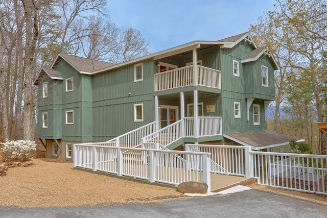 view of front of house with a balcony and a shingled roof
